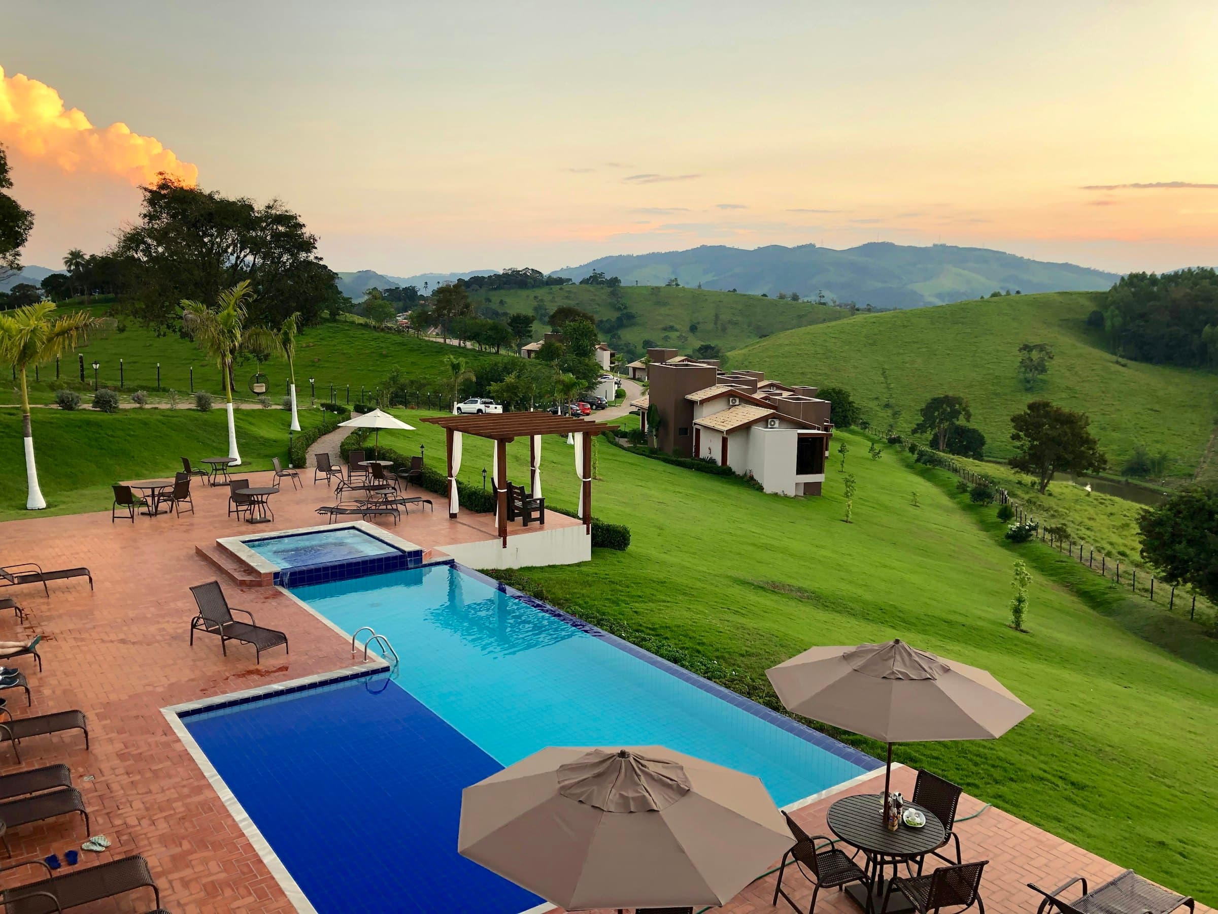 Historic wine estate outdoor dining courtyard with parasols and lush gardens